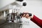 Close-up of a barista hand installs a coffee cup for coffee maker