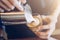 Close-up of Barista pouring hot milk in coffee cup for make latte art.