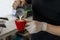 Close up barista pouring steamed milk into coffee cup making beautiful latte, cappuccino art Rosetta pattern. Close up barista