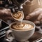 A close-up of a baristas hands creating intricate latte art on the surface of a cappuccino2