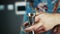 Close-up of a barman measures alcohol with a jigger.