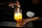 Close-up. Barman`s hand holds strainer near glass with cocktail.