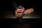 Close-up of bartender with cocktail with flower in hands