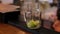 Close-up of bartender making Mojito cocktails with lime, mint and rum in bar.