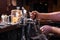 Close-up of bartenders hands pouring beer