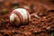 A close-up of a baseball in the dirt