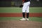 Close up of baseball players legs with black stockings standing