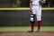 Close up of baseball players legs with red stockings standing on