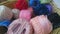 A close up of a basket of coloured cotton reels