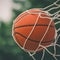 close-up of a basketball going through a hoop.