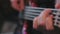 Close up of bass guitarist hands playing guitar