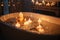 close-up of bathtub filled with warm water and bubbles, surrounded by candles for a peaceful and soothing atmosphere