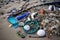 close-up of beach trash, including broken glass and discarded fishing gear