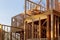 Close-up of beam built home under construction and blue sky with wooden truss, post and beam framework. Timber frame house, real