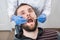 Close up of bearded man having dental check up in dental clinic