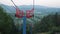 Close up of bearing while ski chairlift passing by. Steel cables of ski lift in mountains. Chairlift mechanism. Steel rope tow in