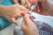 Close up of Beautician with Electric Nail Drill in Beauty Manicure Salon