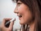 Close up Beautiful Asian Woman Putting Makeup Lipstick, Happy Woman Concept, Cinematic