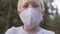 Close-up of a beautiful blond boy in a large protective mask