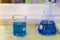 Close up of beautiful blue colorful chemistry liquid in various laboratory flask for science