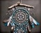 Close up of beautiful boho styled dreamcatcher with blue feathers and beads against black