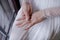 Close-up of beautiful bride\'s hands, perfectly manicured, with focus on the delicate solitaire engagement ring