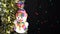 Close-up of beautiful Christmas tree toys snowman on tinsel.