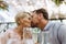 Close up of beautiful couple in a restaurant, on romantic date. Wife and husband kissing, having romantic moment at