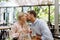 Close up of beautiful couple in restaurant, on a romantic date. Wife and husband kissing, having romantic moment at