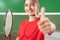 Close up of beautiful girl badminton player with thumbs up