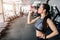 Close up of a beautiful girl drinking water from the bottle. He is having some rest after workout. Cut view.