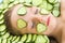 Close up of beautiful girl with facial mask of cucumber