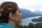 Close-up, beautiful girl looks at the Molveno lake on the horizon from the Pradel plateau in Trentino.