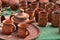 Close up of beautiful Gujarati Khavda Pottery earthen decorated terracotta crockery tea cups, kettle and tray with glasses at a