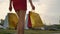Close-up beautiful legs of young shopping woman female in red dress with bags packages