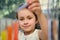 Close-up. Beautiful little schoolgirl making experiments while learning chemistry. Blurred test tubes on the foreground