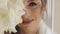 Close-up of beautiful lovely stylish bride girl looking at camera and smiling with flowers bouquet