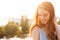 Close up of a beautiful redhead girl playing with hair