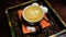 Close up of beautiful serve of cup of coffee in stand with coffee beans. Top view of mug of cappuccino with sugar and