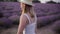 Close up of a beautiful smiling girl in a hat on a lavender field. Summer time dawn. focus of woman flirting enjoying a