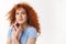 Close-up beautiful tender redhead woman with blue eyes, standing white background, ginger curly hair floating air