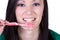 Close up of a beautiful woman brushing her teeth