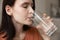 Close up beautiful woman with perfect skin drinking mineral water