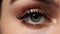 Close-up of beautiful woman\\\'s eye with golden make-up