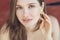 Close-up of a beautiful woman in shiny gold earrings. Portrait of a young woman in costume jewelry.