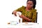 Close-up of a beautiful woman sitting at dining table spilling water into a glass