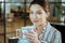 Close up of beautiful woman wearing nice jewelry drinking tea