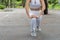 Close up beautiful woman wearing white sports warm up before exercise. Sporty female warming up before running in the public