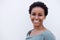 Close up beautiful young black woman smiling against white background