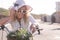 Close up of beautiful young woman enjoying excursion outdoor with a vintage bicycle. Large smile and white sunglasses. Curly hair